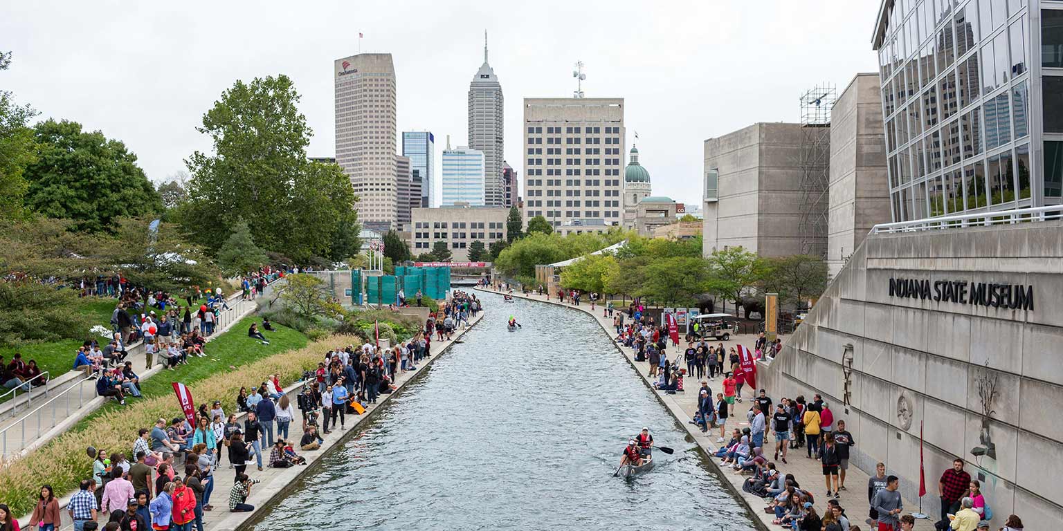 An aerial view of the race on the canal with the Indianapolis skyline in the background.
