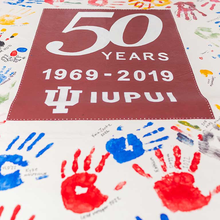 The Herron School of Art celebrates IUPUI's 50th Anniversary with a hand print and signature display.